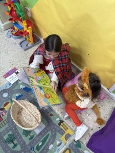 Primary school pupil captioning an Early Years pupil